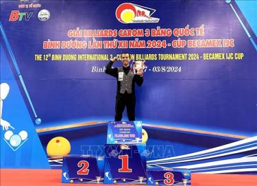 Trần Quyết Chiến lên bục nhận Cup nhà vô địch Giải Billiards Carom 3 băng Quốc tế Bình Dương lần thứ 12 năm 2024. Ảnh: TTXVN phát